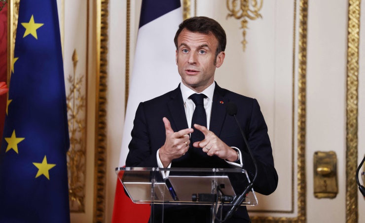 Macron Sign France's Macron signs contested pension law as unions plan more protests